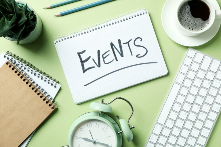 Events concept with alarm clock on green background
